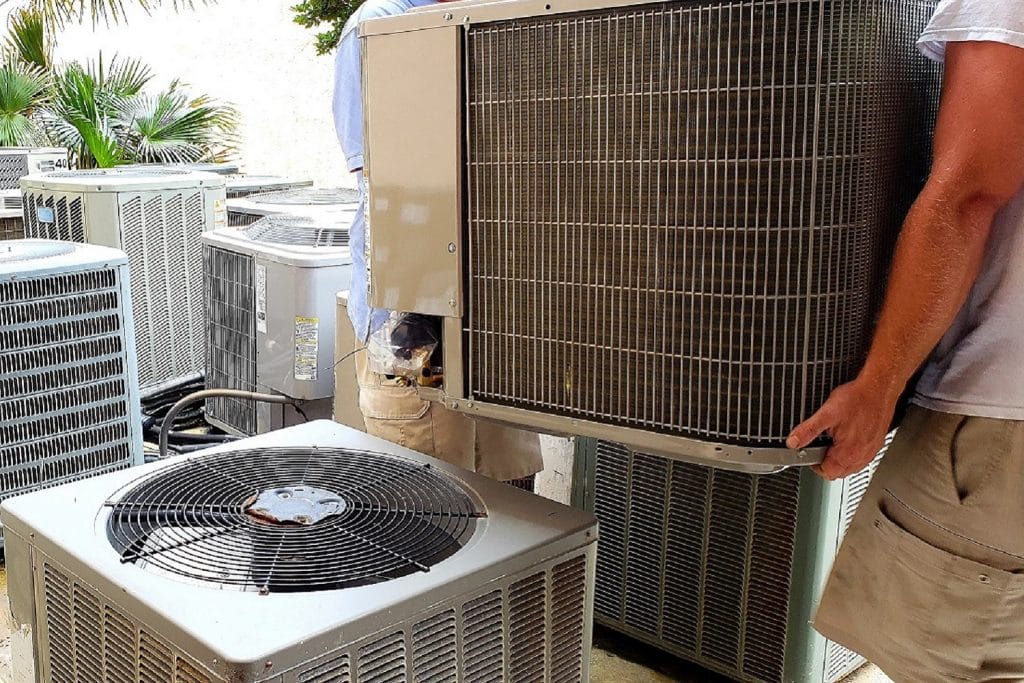HVAC Technician Removing Old Rusted Broken AC